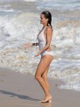 Brooke Burke wearing white swimsuit before she goes topless on beach in St. Barths