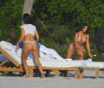 Kim Kardashian and Kourtney Kardashian take a walk on the beach in Mexico