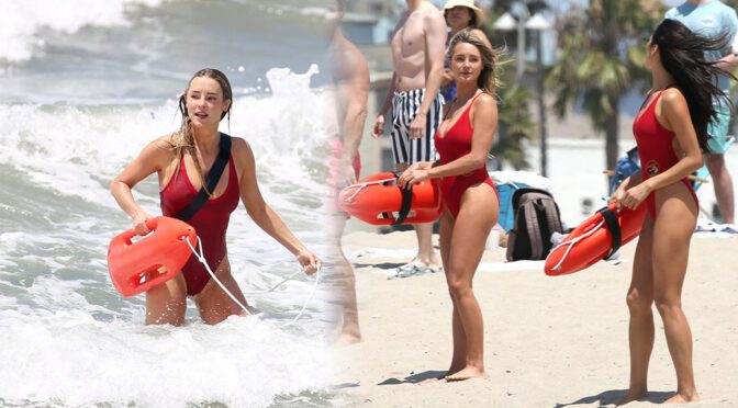 Blonde Bombshell Hassie Harrison Soaks Her Massive Cleavage in Iconic Baywatch One-Piece