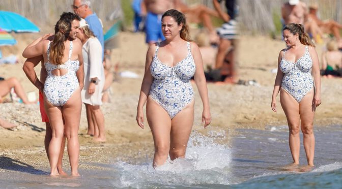 Thick and Busty! Kelly Brook Spills Out of Tight Swimsuit on the Beach
