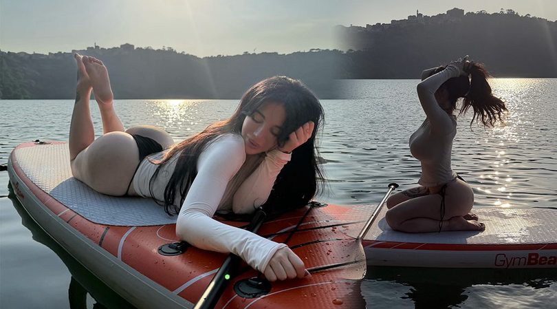 Alexis Mucci Catches Golden Hour on a Paddleboard in a Form-Fitting White Top and Black Thong