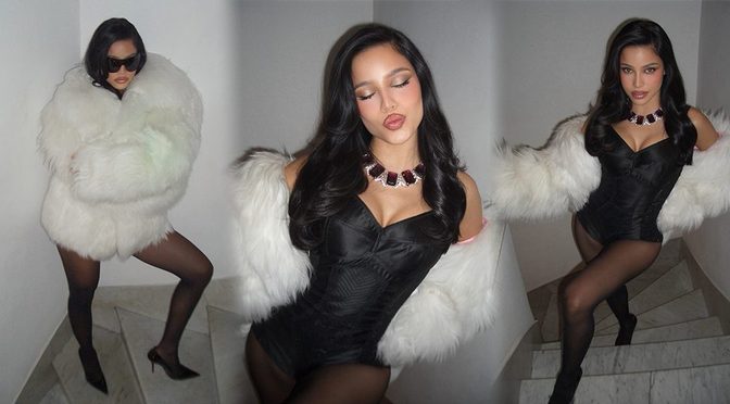Emilia Mernes Spills Cleavage in Black Corset While Wrapped in White Fur